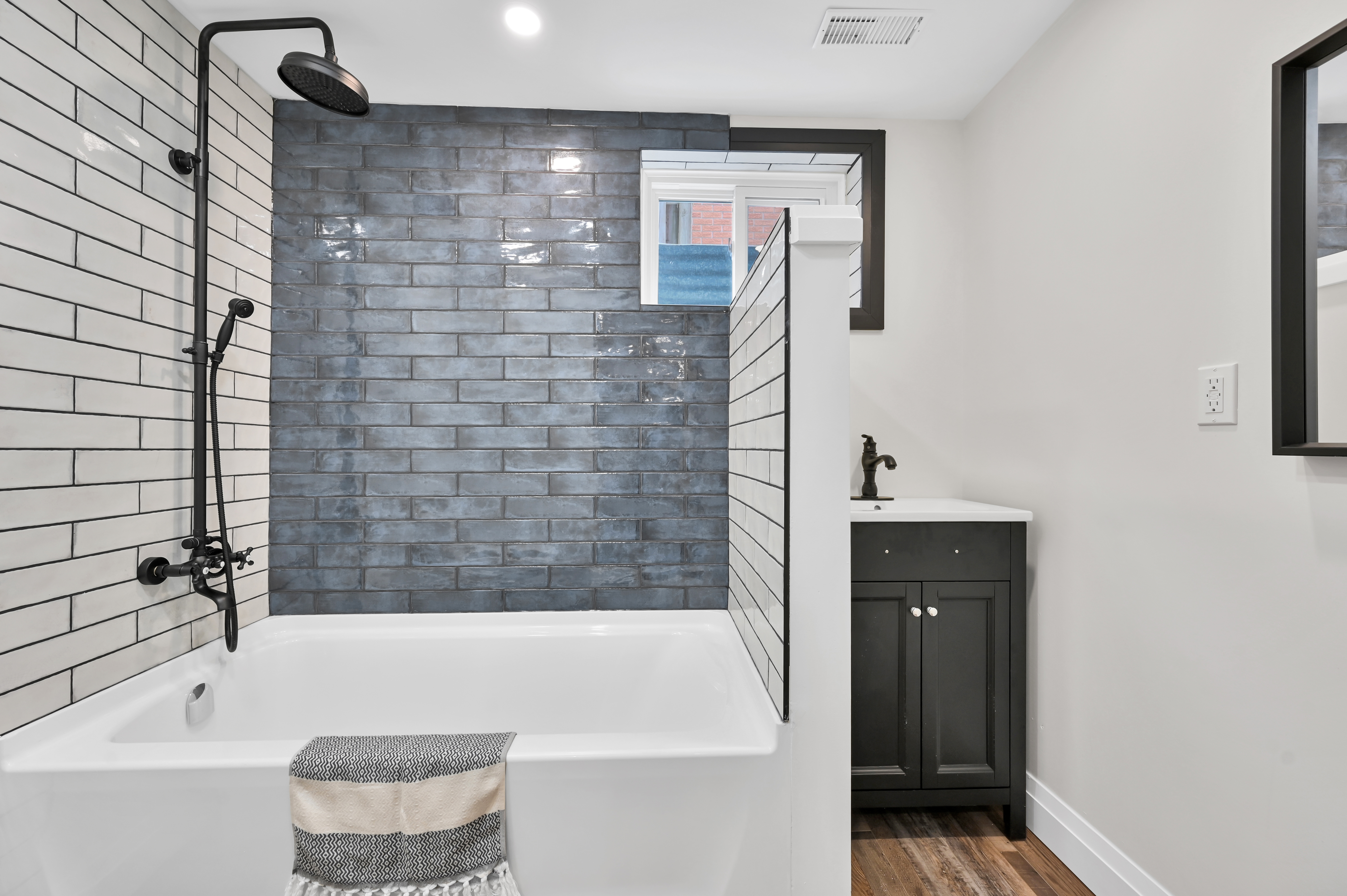 Beautifully finished bathroom with striking blue accent tile and professional staging — premium portfolio shot — Kron, Hamilton | MTC Renovations